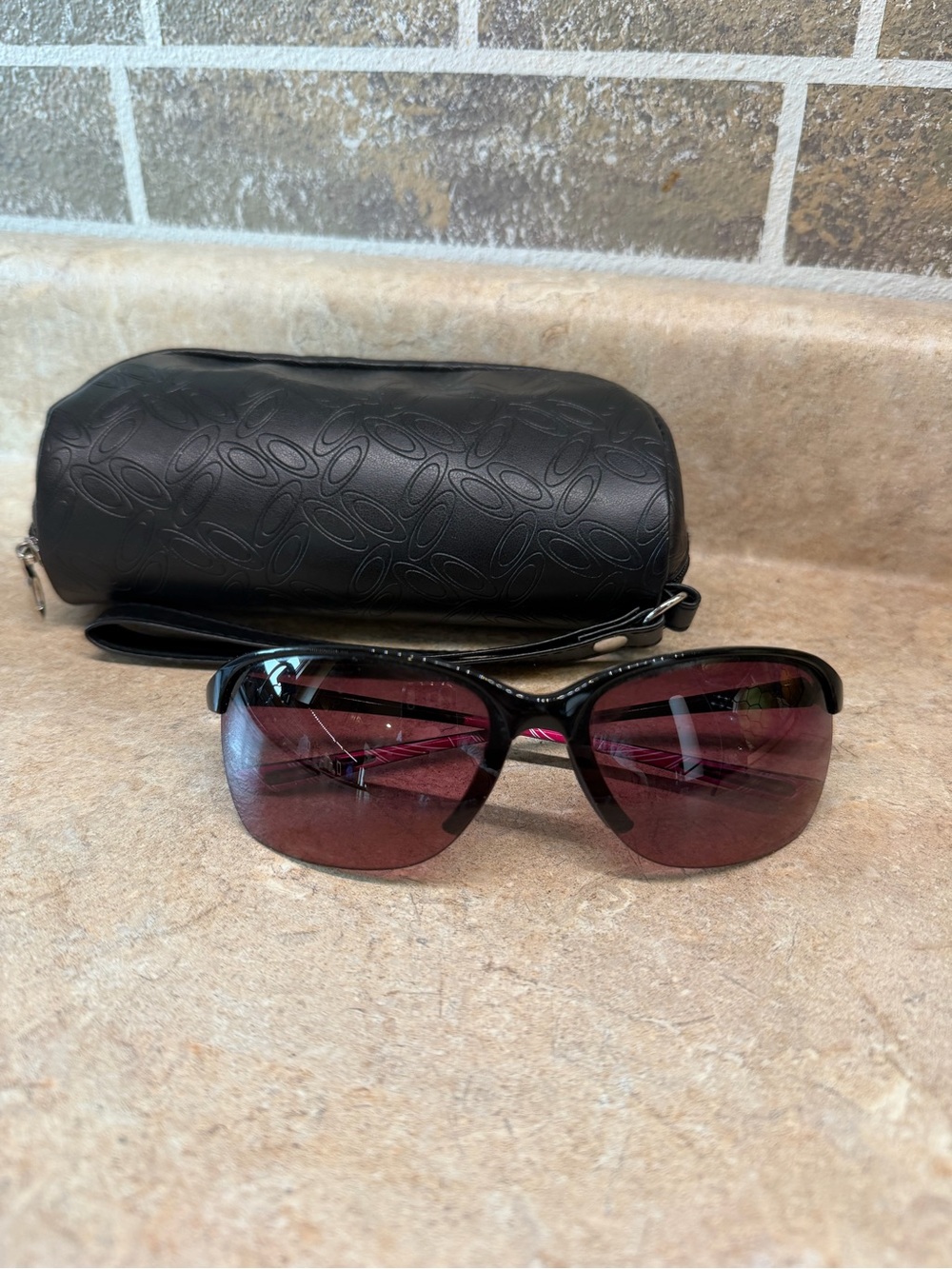 Oakley UNSTOPPABLE Black Frame Sunglasses with Rose Gradient Polarized Lenses